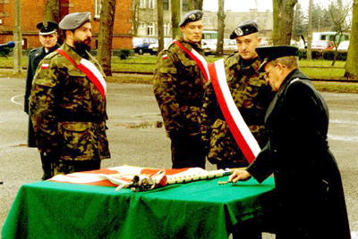 Wbijanie ostatniego gwoździa do drzewca sztandaru przez D-cę 26 BR.